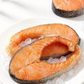 Raw salmon cross-cut portions resting on crushed ice