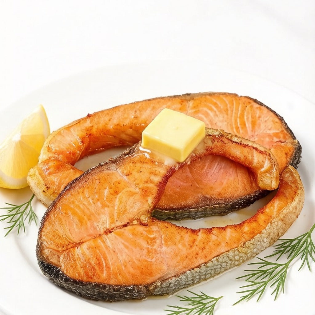 Pan-seared salmon portion with a pat of butter, lemon and dill